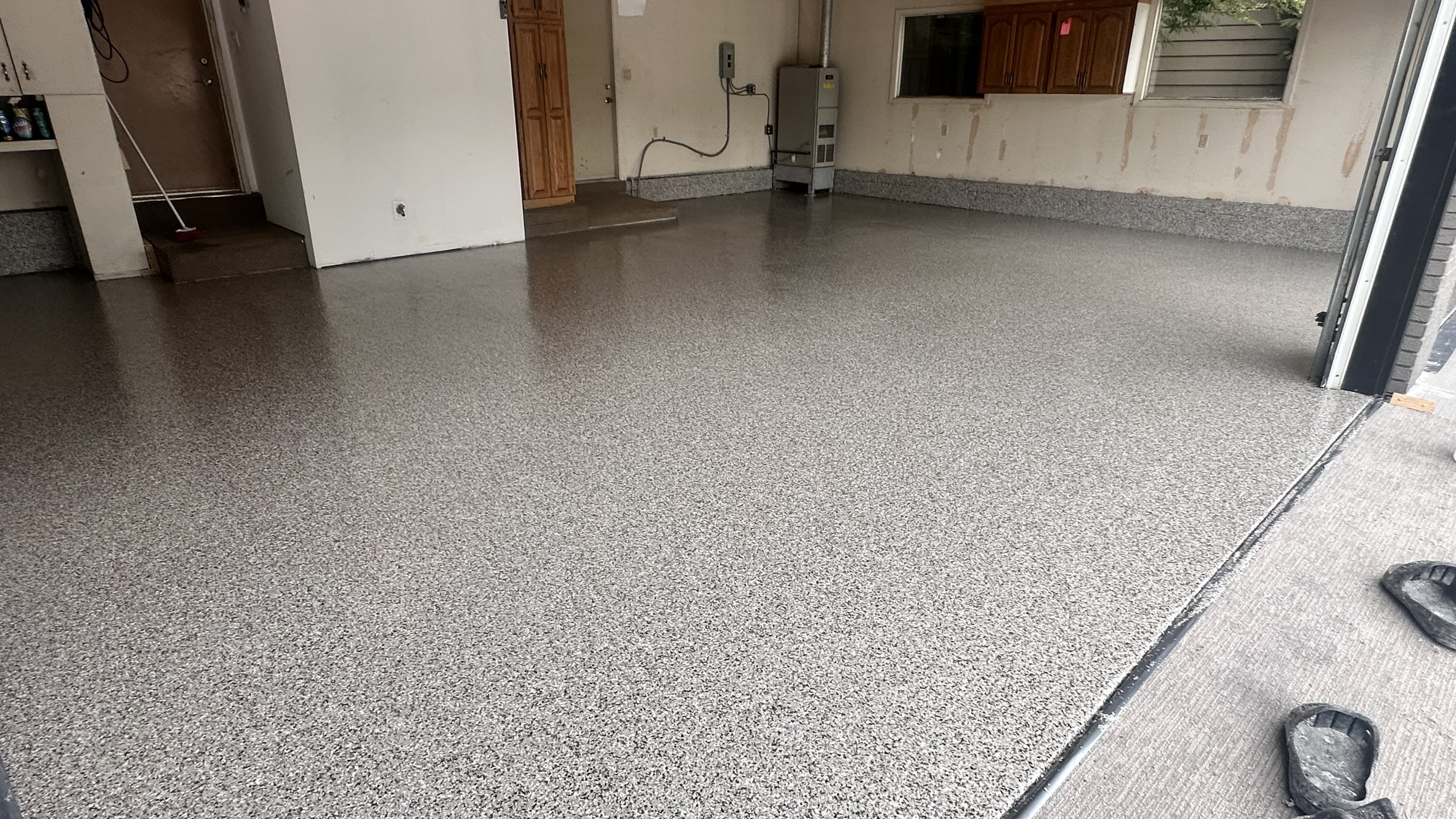 Concrete Repair Services Jacksonville, FL | Con Cure USA IMG 7539 Cracked concrete floor with exposed rebar, showing disrepair and structural issues in sunlight.