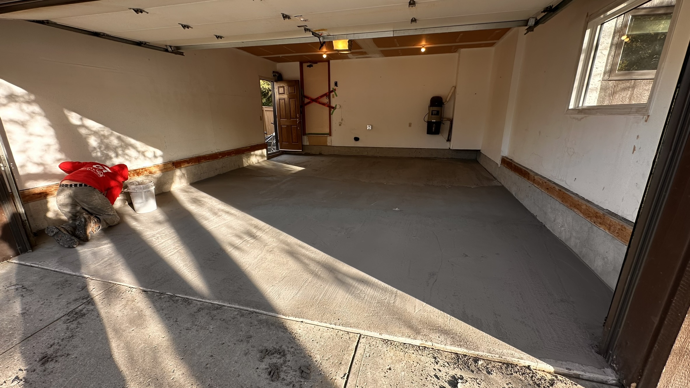 Concrete Repair Services Jacksonville, FL | Con Cure USA IMG 8167 Freshly poured concrete repair and floor in a garage, showing a mix of smooth and rough patches