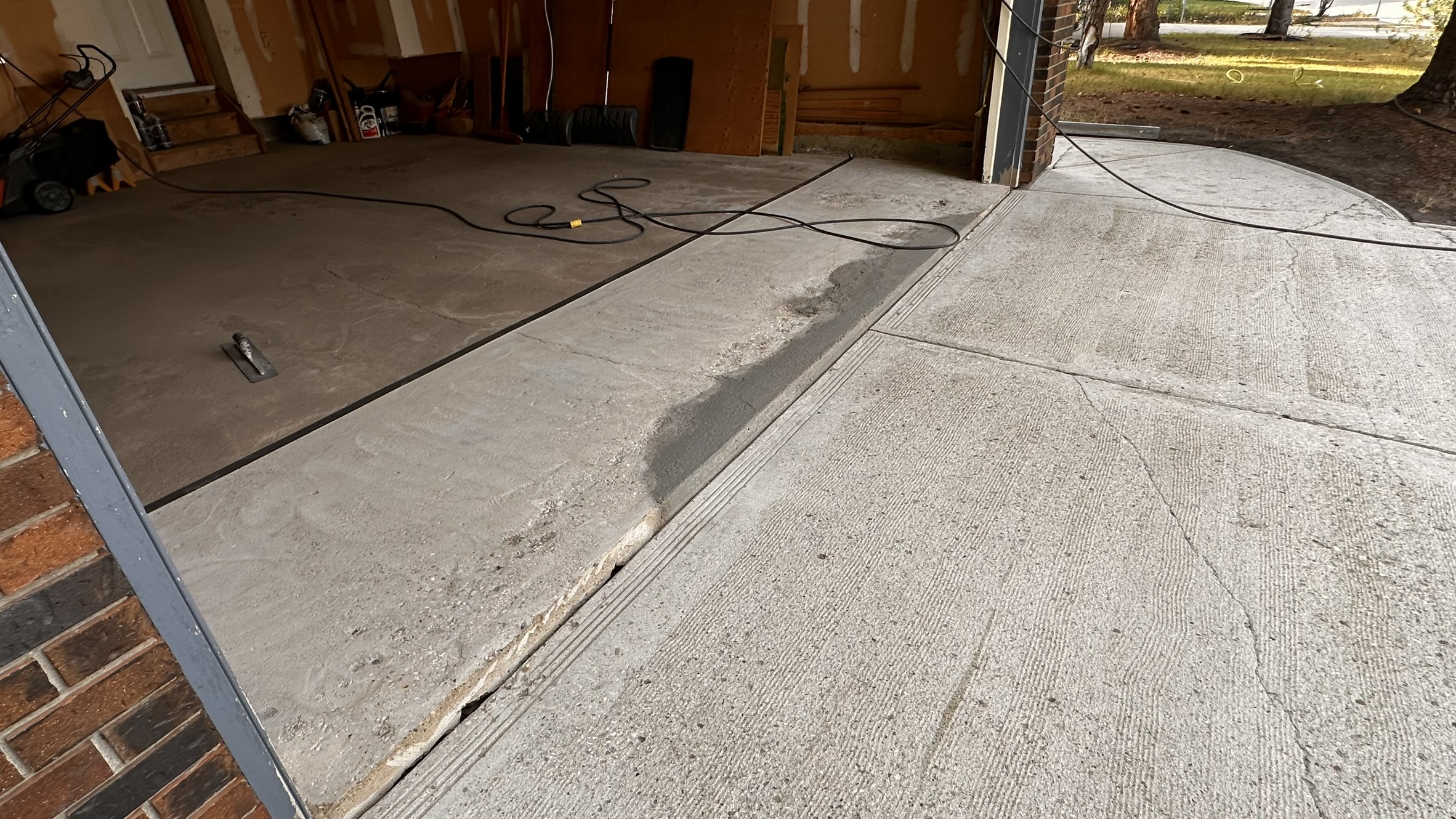 Concrete Repair Services Jacksonville, FL | Con Cure USA IMG 8223 Freshly poured concrete repair and floor in a garage, showing a mix of smooth and rough patches
