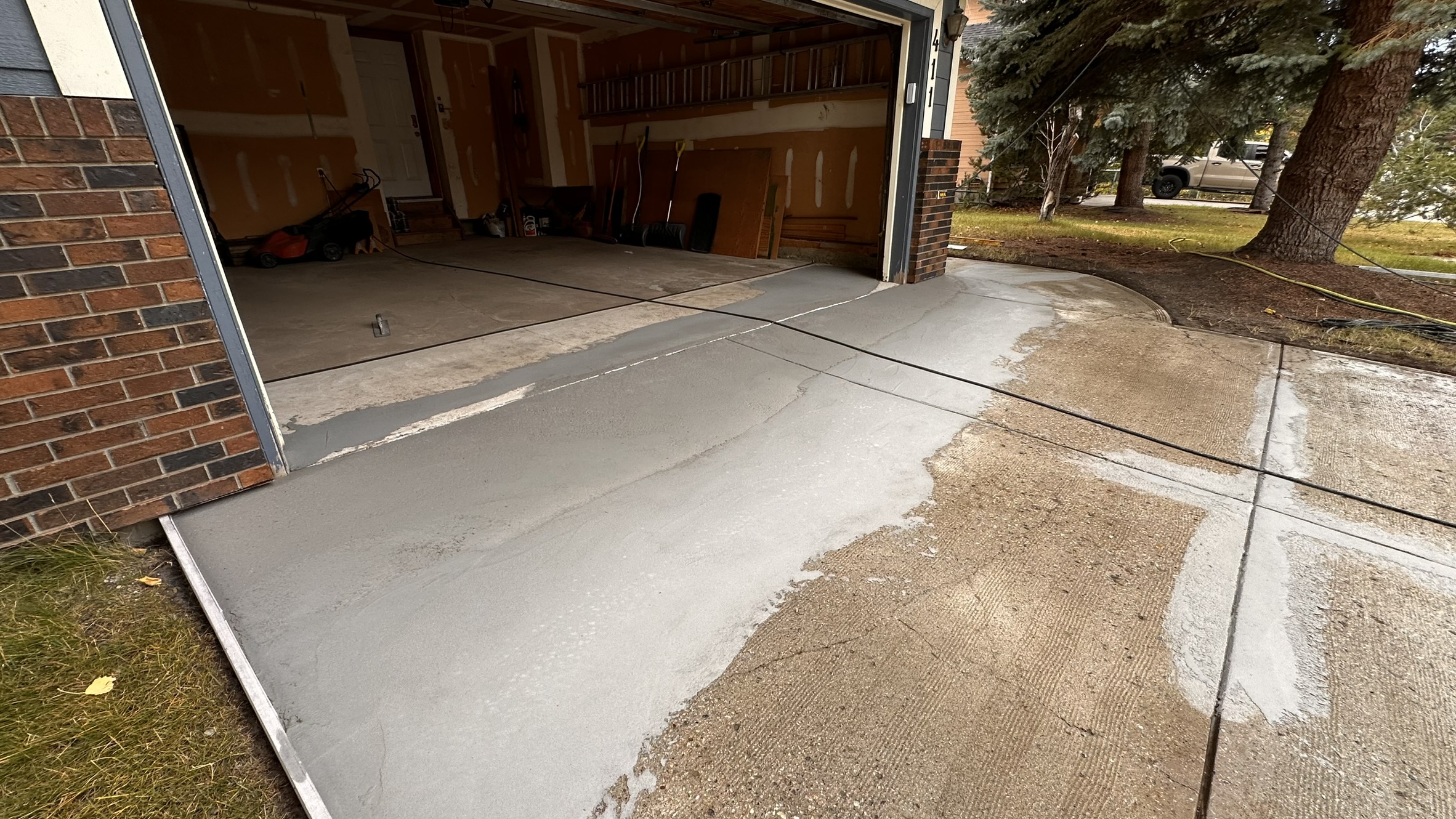 Concrete Repair Services Jacksonville, FL | Con Cure USA IMG 8231 1 Freshly poured concrete repair and floor in a garage, showing a mix of smooth and rough patches