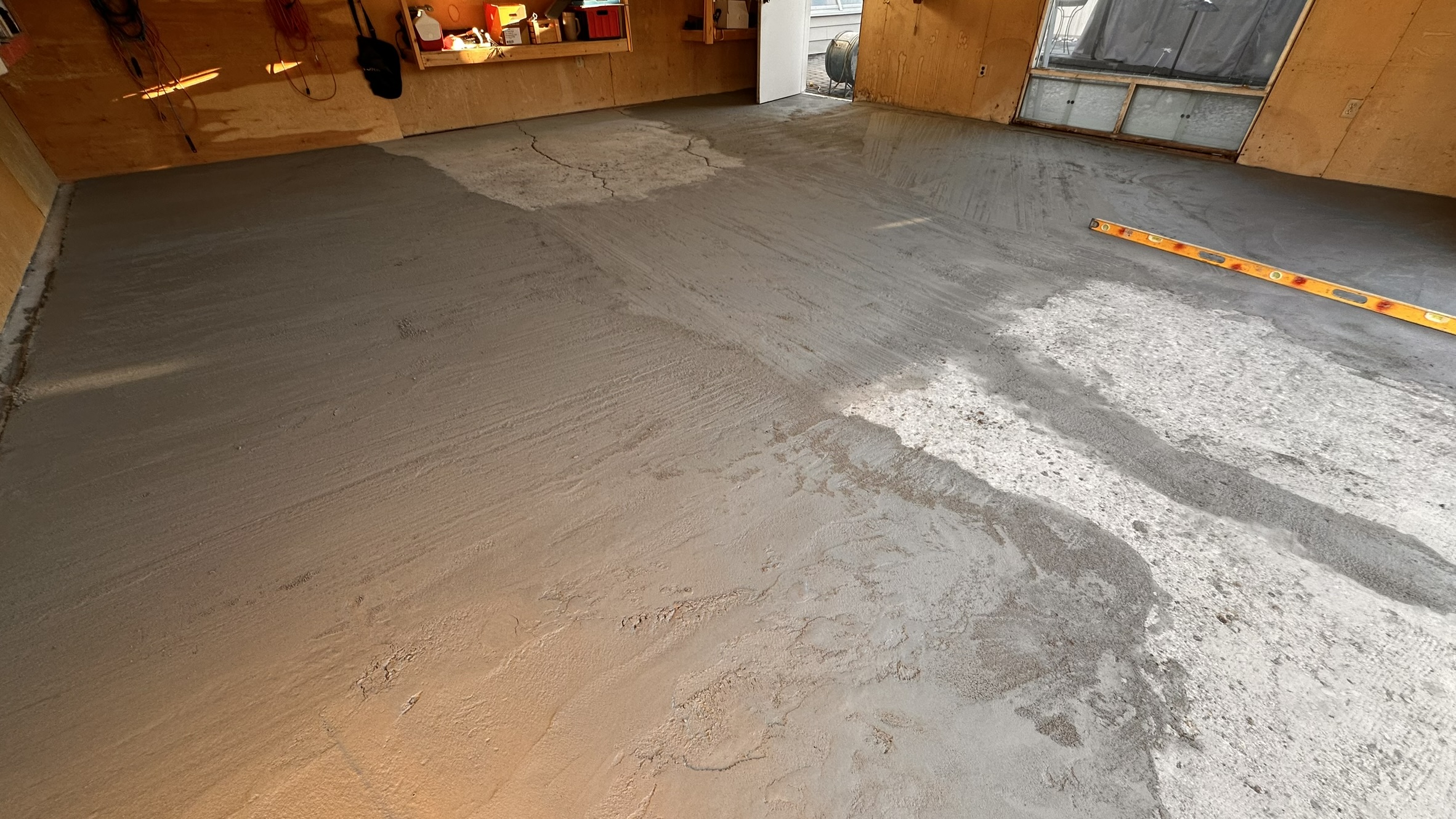 Concrete Repair Services Jacksonville, FL | Con Cure USA IMG 8591 Freshly poured concrete repair and floor in a garage, showing a mix of smooth and rough patches