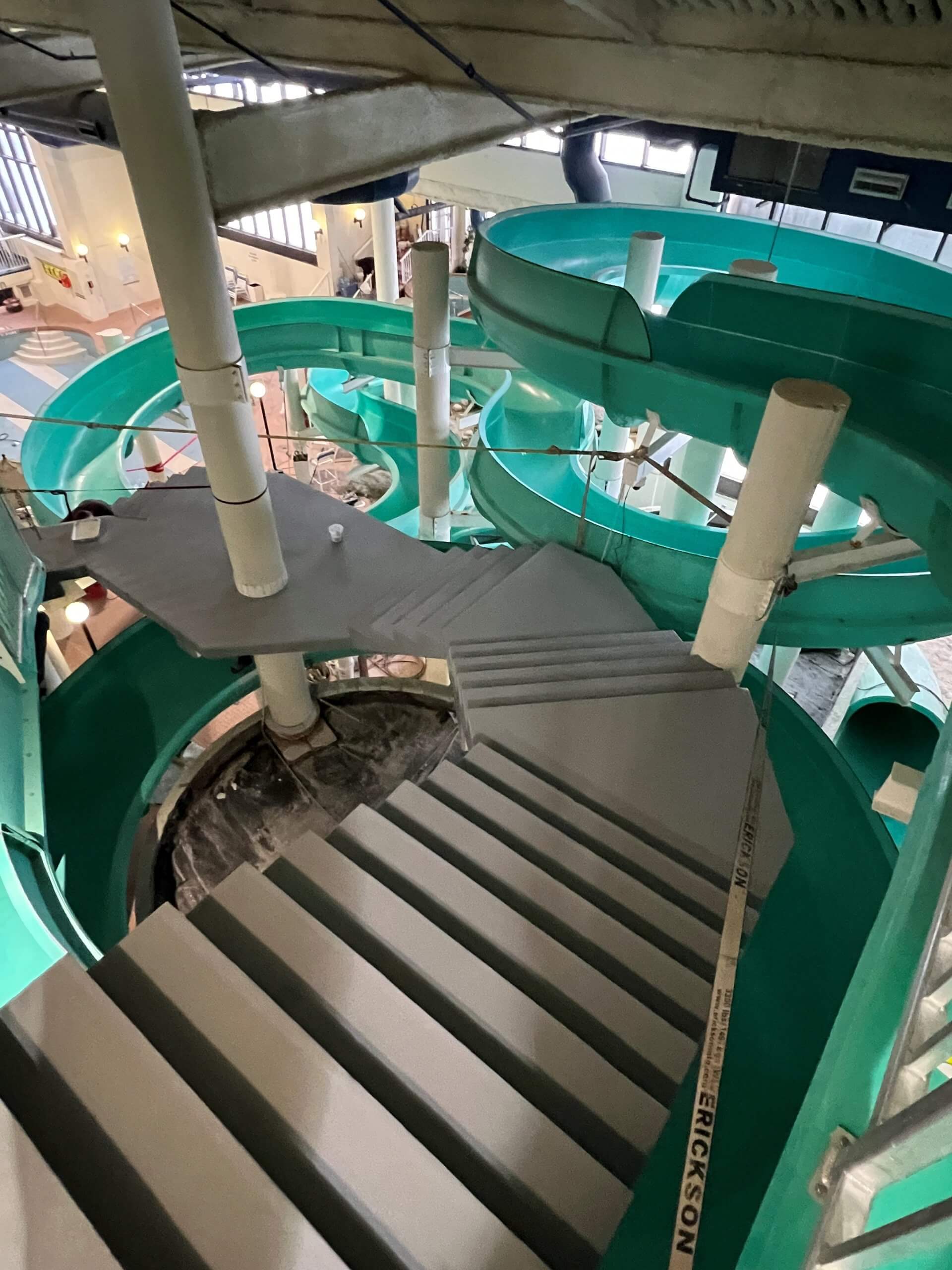 Large pool featuring a slide and stairs, designed for fun and relaxation. Con Cure Restoration enhances the experience.